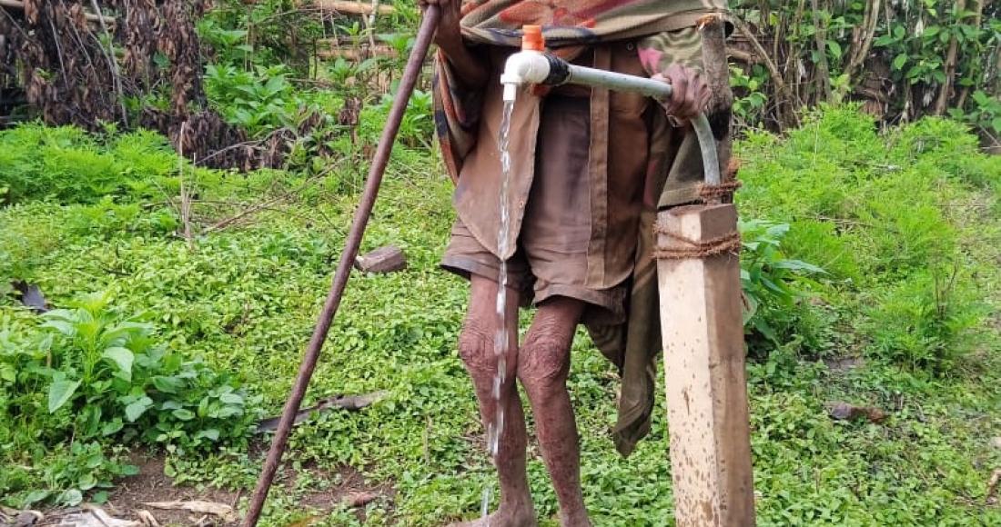 Meshang- a 90-year-old from Nokhu Village under Noklak District collecting potable water from the pipe supplied by JJM under PHED.