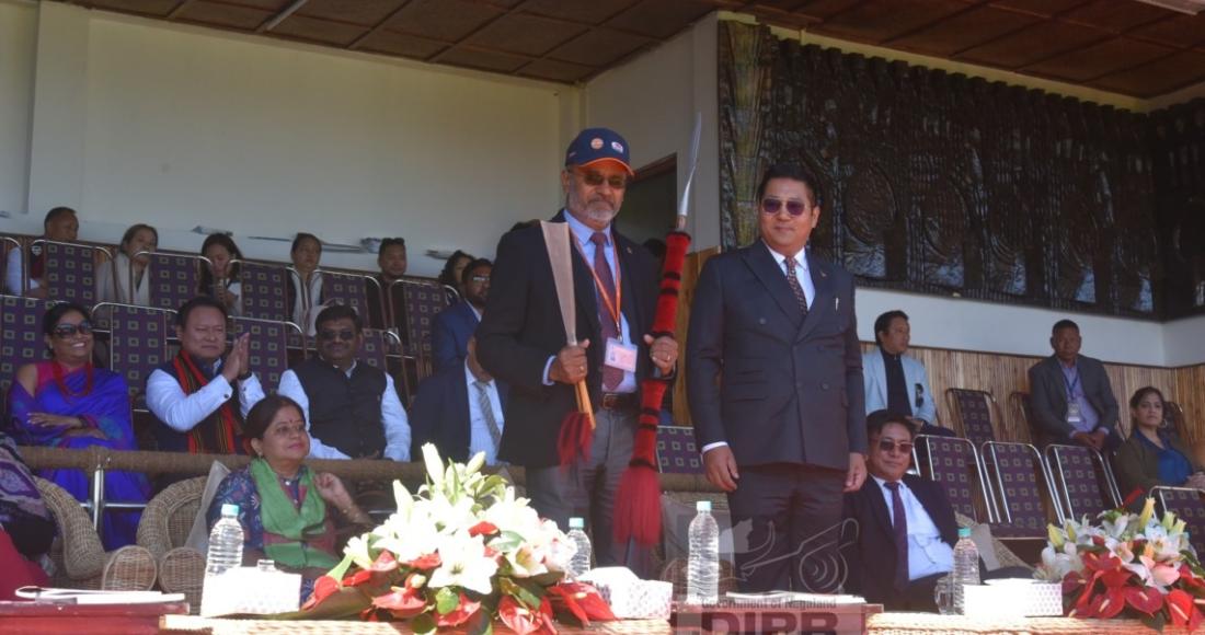 G. Ramesh, ex. Director being presented with a naga spear