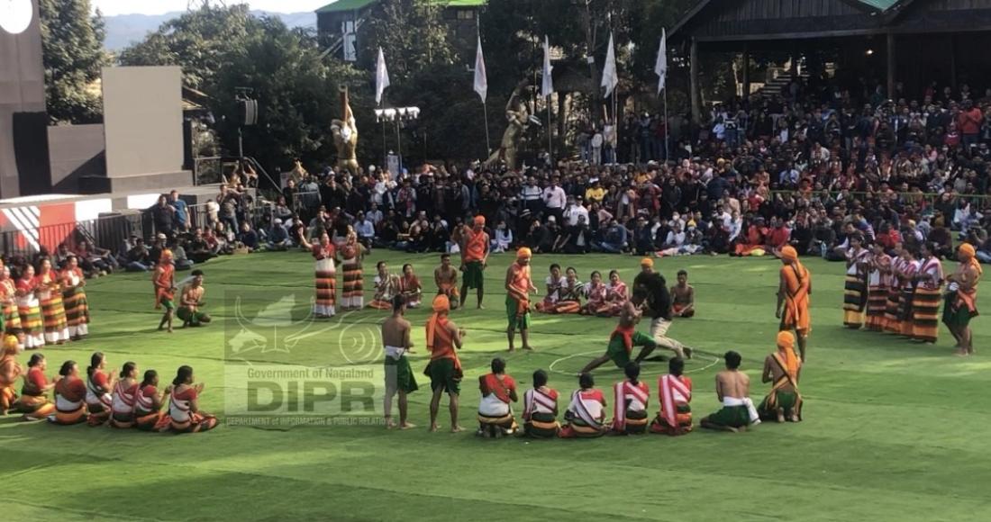 Tourist taking part in the indigenous game of Kachari