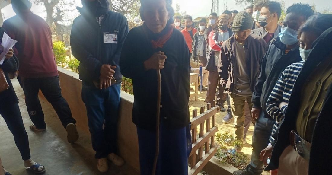 84 years old senior citizen standing in the queue to cast her vote at Tening