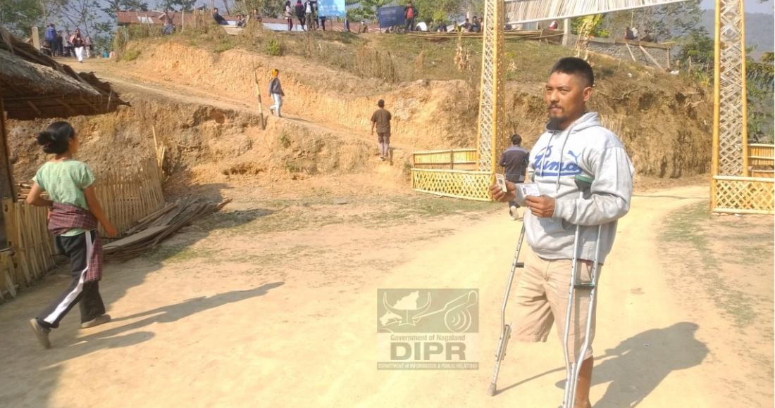 A differently abled person showing his EPIC card after casting his vote at Polling Station no. 35, Auching village under 50 A/C Longleng. (DPRO Mon)