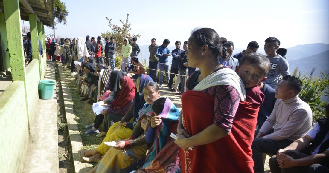 A mother waiting to cast her vote