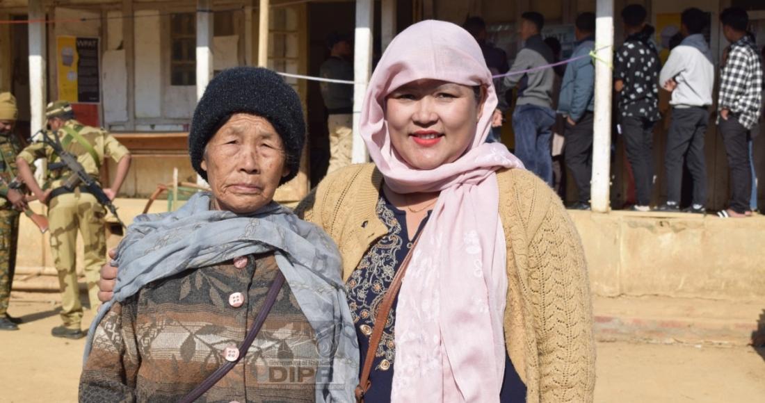 An elderly woman being assisted by her daughter before casting vote at 74-Peren