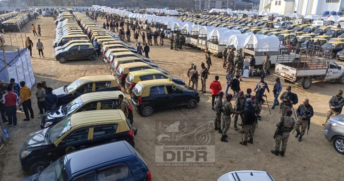 Vehicles and security personnel moving out from IG Stadium to the collecting and receiving centre at DC office Kohima